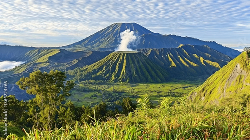 Aerial View of Green Volcanic Landscape with Steam Venting Under Blue Sky with Clouds in Java Indonesia