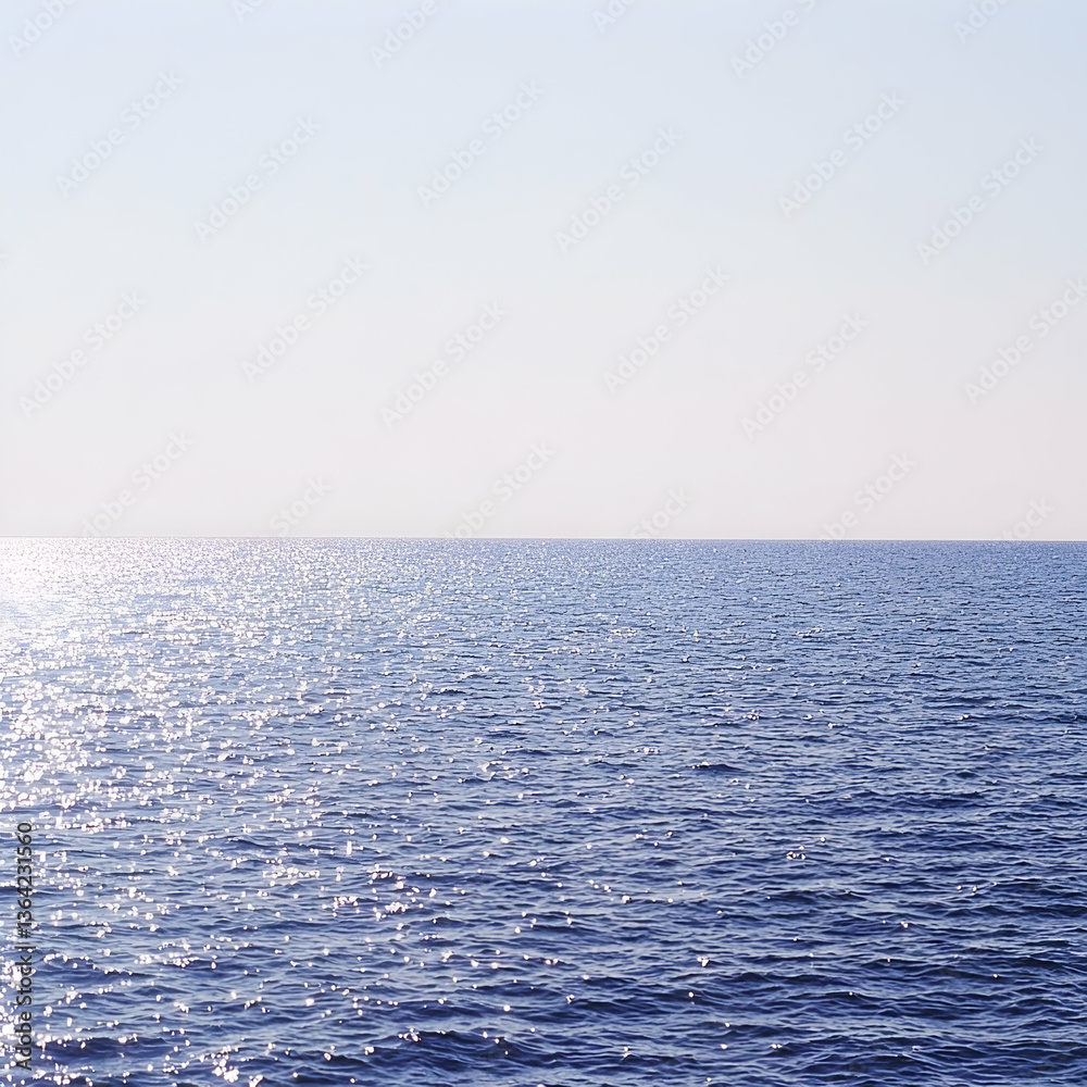 Fototapeta premium Calm ocean surface, sun reflecting, clear sky, peaceful seascape, ideal for travel brochures