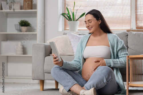 Young pregnant woman using ...