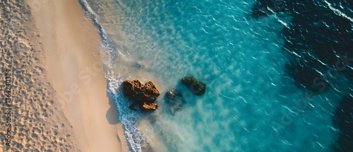 Breathtaking aerial view of the clear waters and sandy shores of a tranquil beach with a cinematic minimalist lighting that creates a captivating and peaceful atmosphere photo