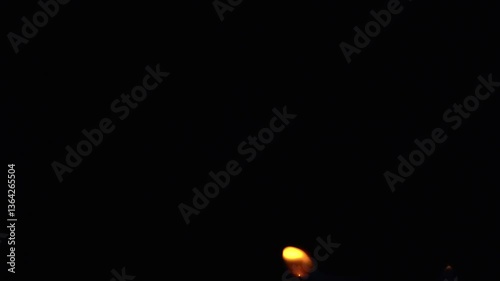Flames are burning isolated on a black background. Concept of particles, sparkles, flame and light.