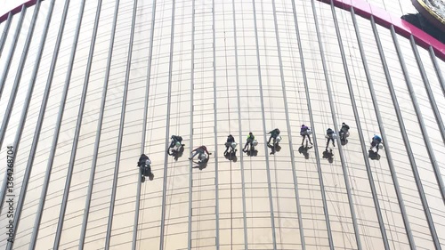 Many workers are cleaning the windows of high-rise buildings, requiring special expertise