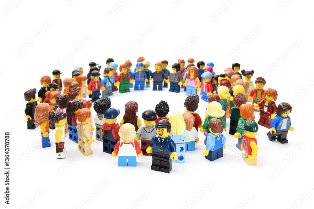 Naklejka premium Many lego minifigures in group in circle shape isolated on white. Editorial illustrative image of popular children plastic constructor with studs.