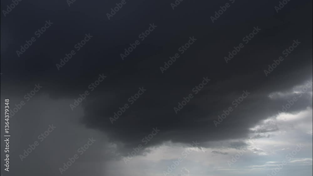 Dramatic time-lapse of dark storm clouds forming and rain approaching over the horizon. Perfect for weather-related, nature documentaries, or cinematic backgrounds. Dramatic time-lapse of dark storm clouds forming and rain approaching over the horizon. Perfect for weather-related, nature documentaries, or cinematic backgrounds.