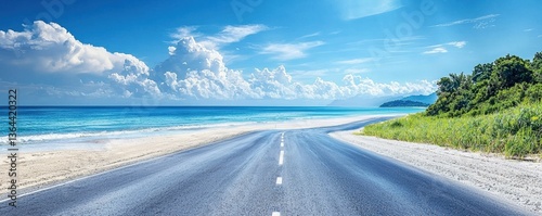 Endless road leading to a serene beach under a vibrant sky.