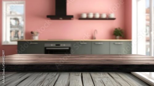 Empty wooden kitchen table top in front of a blurred pink kitchen.