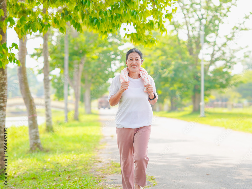 Senior Asian woman enjoys jogging in summer, embracing wellness lifestyle with technology. Wearing smartwatch, people stays connected to health, promoting positive aging. workout is relax happiness Senior Asian woman enjoys jogging in summer, embracing wellness lifestyle with technology. Wearing smartwatch, people stays connected to health, promoting positive aging. workout is relax happiness