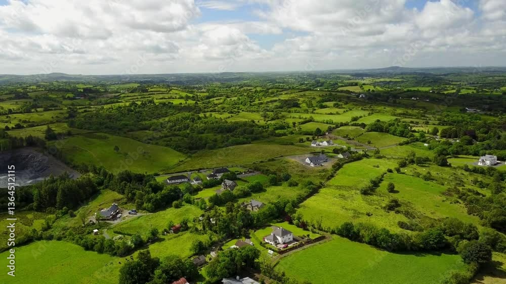Panoramic view of green fields, hills, and clouds over a peaceful countryside with a river and village Panoramic view of green fields, hills, and clouds over a peaceful countryside with a river and village