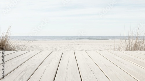 Wooden boardwalk leading to a beach. the boardwalk is made of light-colored wood planks and is empty. the beach is sandy and the ocean is visible in the background.