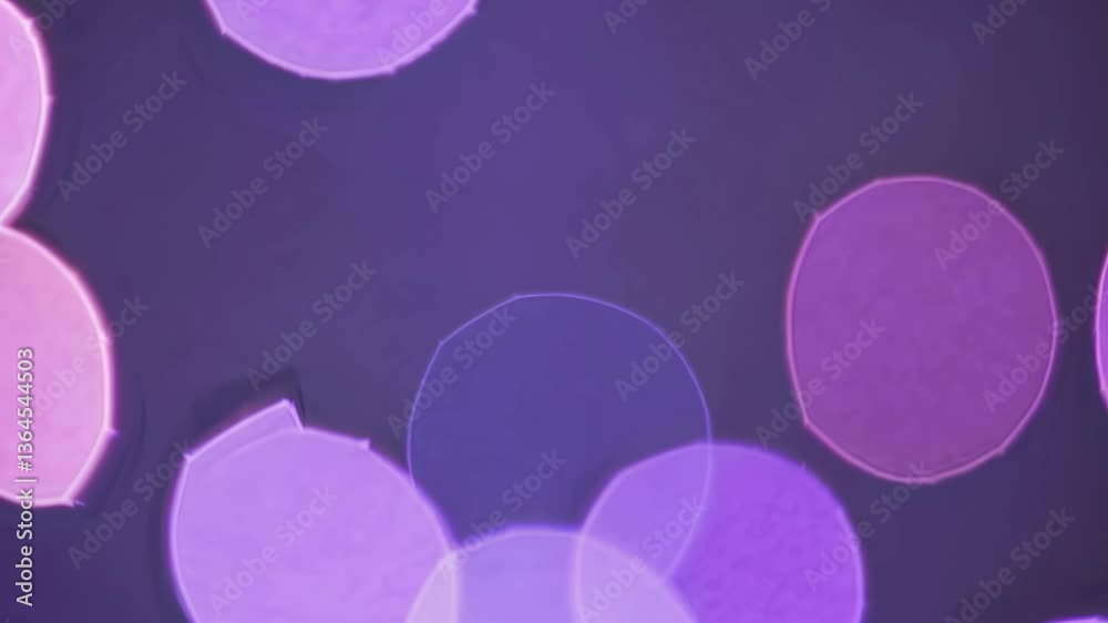 Abstract video with a close-up angle of blurred, glowing circles in warm tones, creating a dreamy, bokeh effect against a dark background. Live desktop wallpaper.