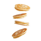 Fluffy pancakes flying in mid air, showcasing golden brown color and light texture, perfect for breakfast or brunch