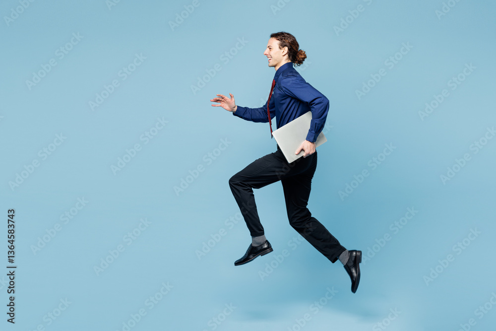 Full body young employee IT business man corporate lawyer wear classic formal shirt red tie work in office jump high hold closed laptop pc computer isolated on plain blue background studio portrait. Full body young employee IT business man corporate lawyer wear classic formal shirt red tie work in office jump high hold closed laptop pc computer isolated on plain blue background studio portrait.