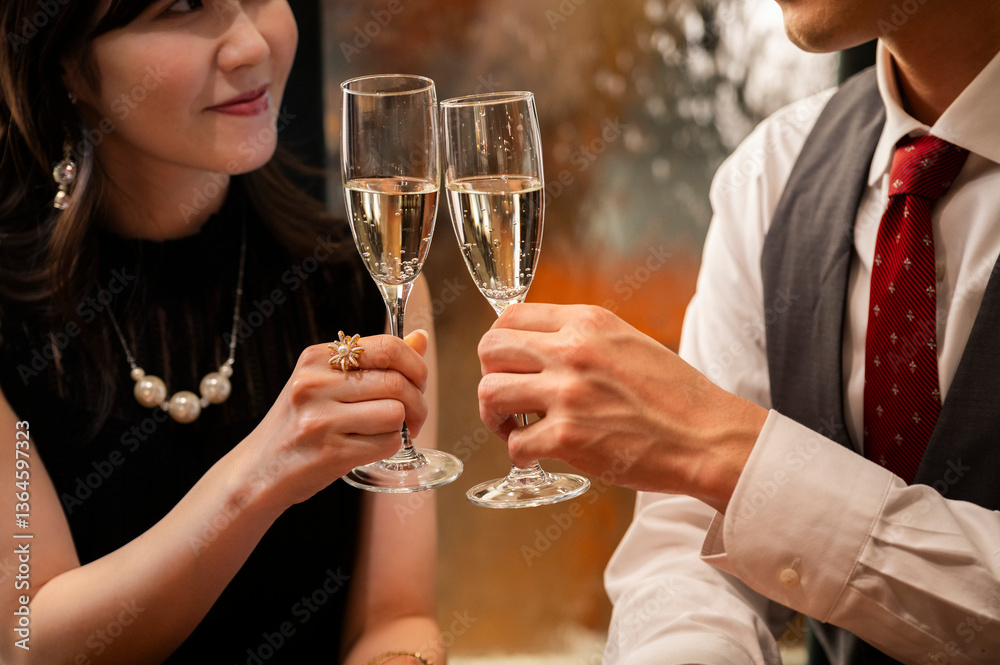 Detailed close-up shot of two champagne flutes clinking together during a toast at an elegant bar. The hands, jewellery, and bubbles emphasize sophistication and celebration.