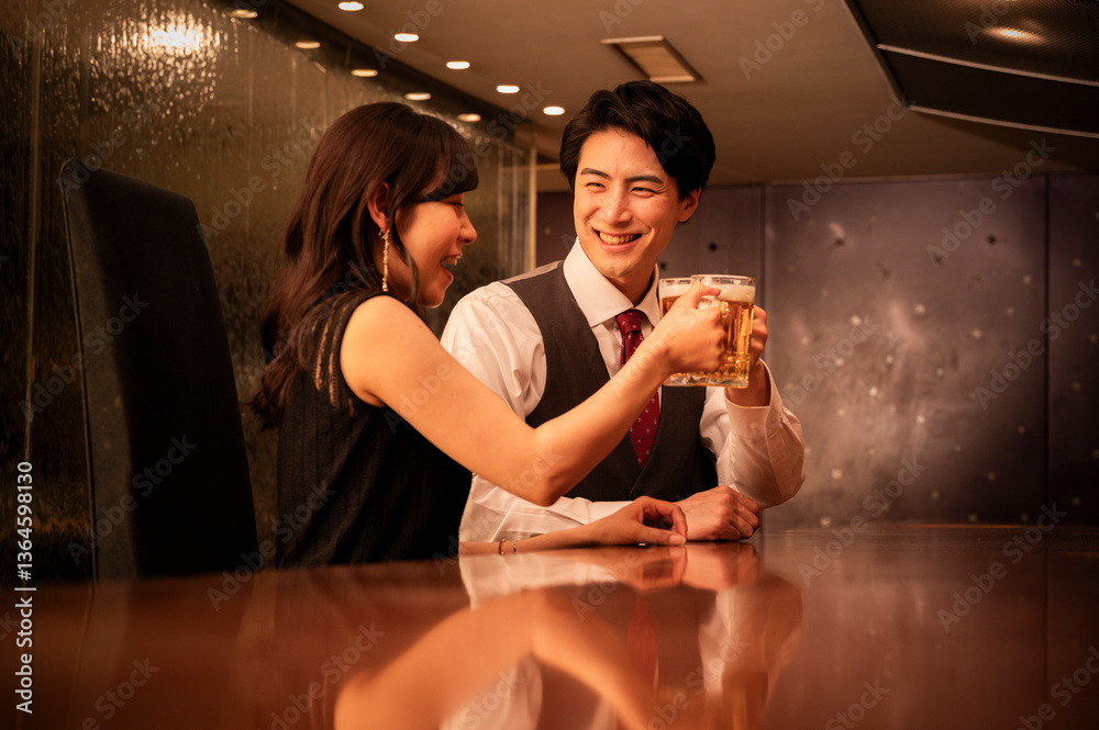 Wide view of a man and woman sitting close together at a stylish bar, enjoying champagne and intimate conversation in a luxurious evening atmosphere.