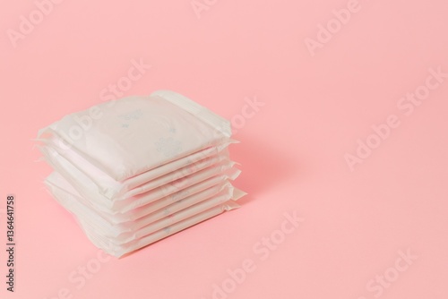 Sanitary pads packed on pink background. Concept of menstruation, ovulation, reproduction, pain and personal hygiene. Flat layout