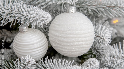Snowy Christmas tree with white ornaments, festive lights
