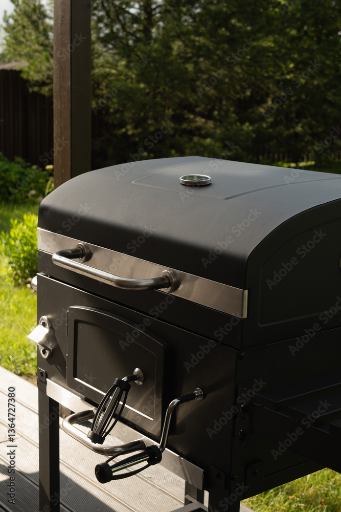 New portable charcoal barbecue grill for summer party at patio. Summer. Outdoors. BBQ grill.