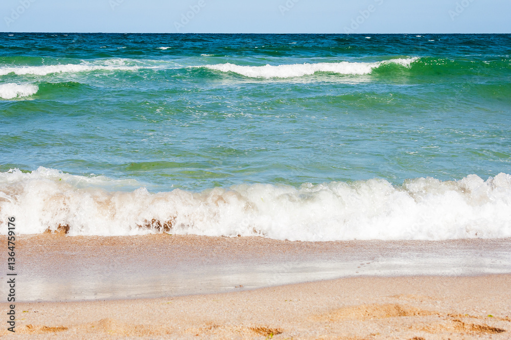 sea scenery in summer. beach with golden sand. wonderful vacation background with transparent calm waves and blue sky. adventure at the sandy seaside