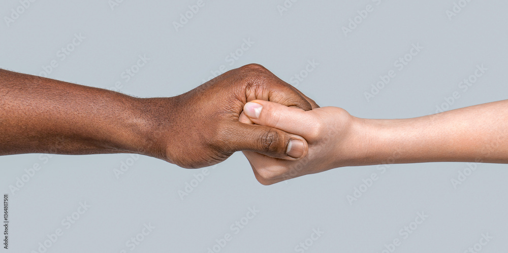 Fototapeta premium Giving a helping hand to another. Woman and african woman hand. Black and white human hands. African and caucasian hands. Helping hand, rescue