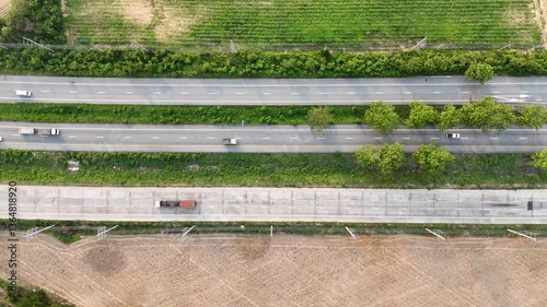 Aerial Landscape of Highway with Vehicles in Green Fields and Agriculture, Showcasing Natures Harmony with Transportation on Road.