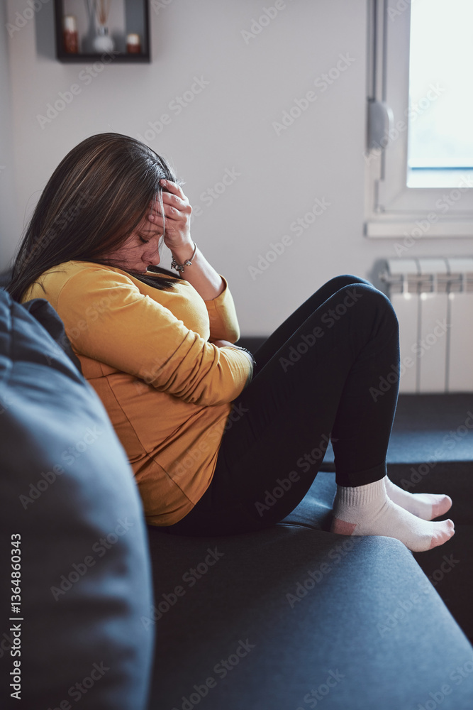 Woman with strong stomach ache, menstrual and digestive issues at home.