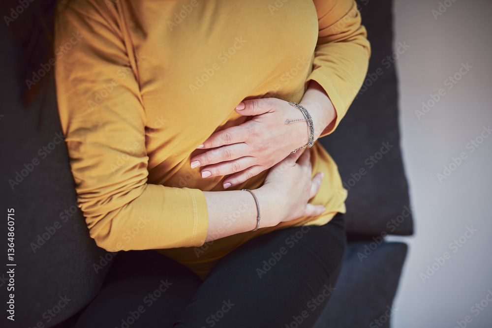 Woman with strong stomach ache, menstrual and digestive issues at home.