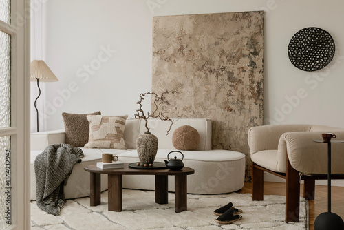 фотографія Bright neutral living space with textured pillows, soft boucle seating, and a ceramic vase as the focal point