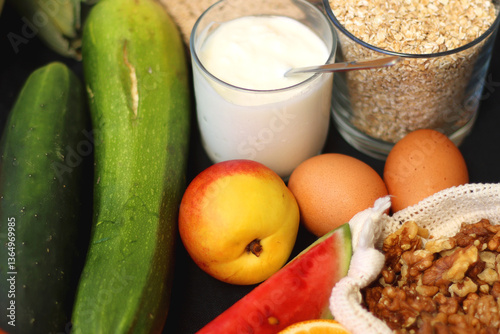 Various healthy fruits, vegetables and cereals on dark background. Selective focus.