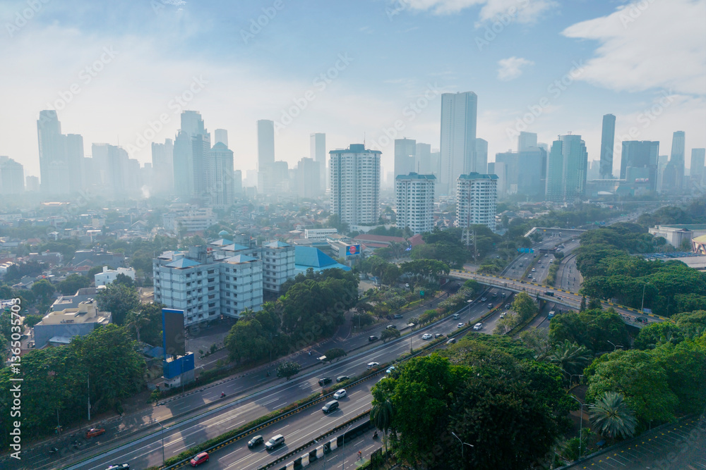 Fototapeta premium Aerial View of Modern Urban Cityscape with High-Rise Buildings and Highway in Jakarta, Indonesia