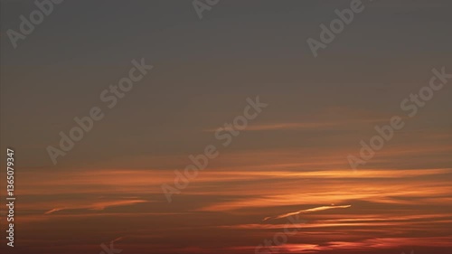 Time lapse. Sunset sky with soft and blur pink and orange pastel colored stratus clouds. Peace and tranquility of the warm summer night