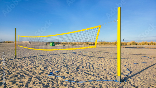 Obraz na płótnie Beach volleyball net on sandy beach and blue sky w salonie