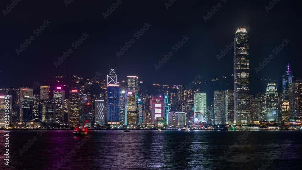 Stunning nighttime timelapse of Hong Kong's skyline showcasing illuminated skyscrapers along Victoria Harbour. Highlights include vibrant city lights and reflections on the water Stunning nighttime timelapse of Hong Kong's skyline showcasing illuminated skyscrapers along Victoria Harbour. Highlights include vibrant city lights and reflections on the water