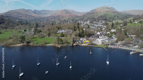 Cinematic drone video retreating from Ambleside town on Windermere with Fairfield Horseshoe fells in the background photo