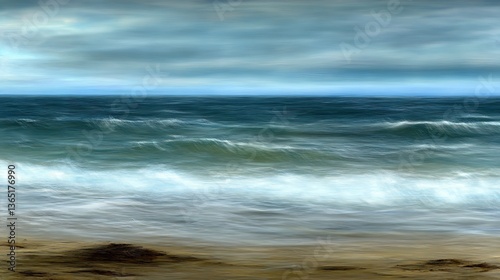 The blurred ocean waves meeting the sandy coastal shoreline under a blue sky