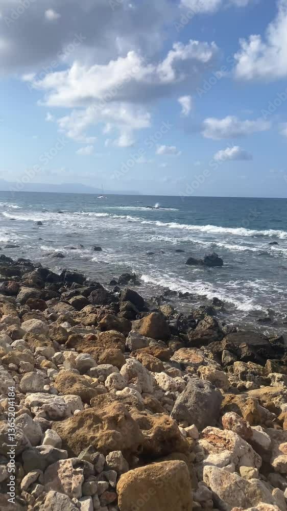 View of the cobblestone shore, mountains and ships in the distance, sea waves, vertical video View of the cobblestone shore, mountains and ships in the distance, sea waves, vertical video