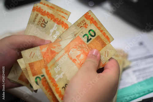 Businessman counting and exchanging money - Brazilian Real - Reais.