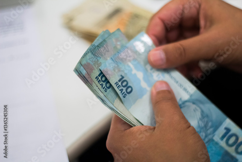 Businessman counting and exchanging money - Brazilian Real - Reais.