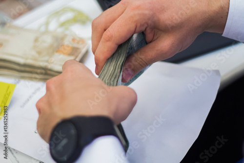 Businessman counting and exchanging money - Brazilian Real - Reais.
