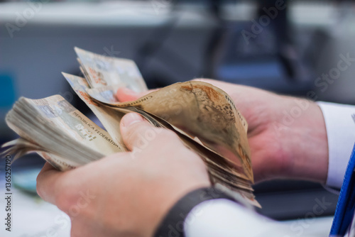 Businessman counting and exchanging money - Brazilian Real - Reais.