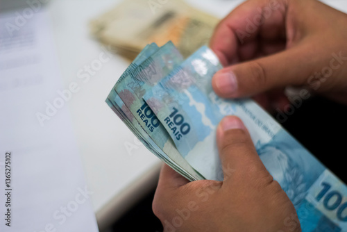 Businessman counting and exchanging money - Brazilian Real - Reais.