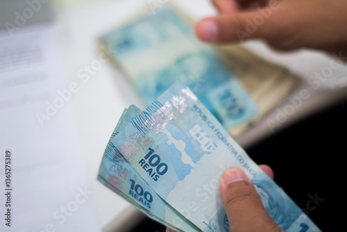 Businessman counting and exchanging money - Brazilian Real - Reais.