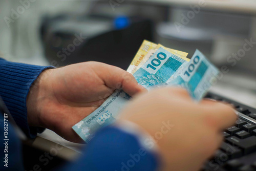 Businessman counting and exchanging money - Brazilian Real - Reais.