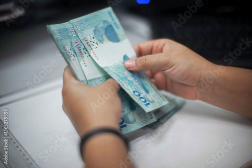 Businessman counting and exchanging money - Brazilian Real - Reais.