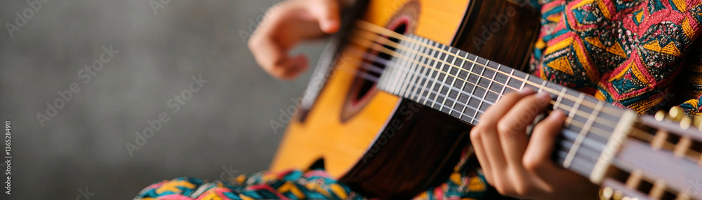 Fototapeta premium person playing wooden guitar, showcasing intricate hand movements and vibrant clothing patterns, creating lively atmosphere