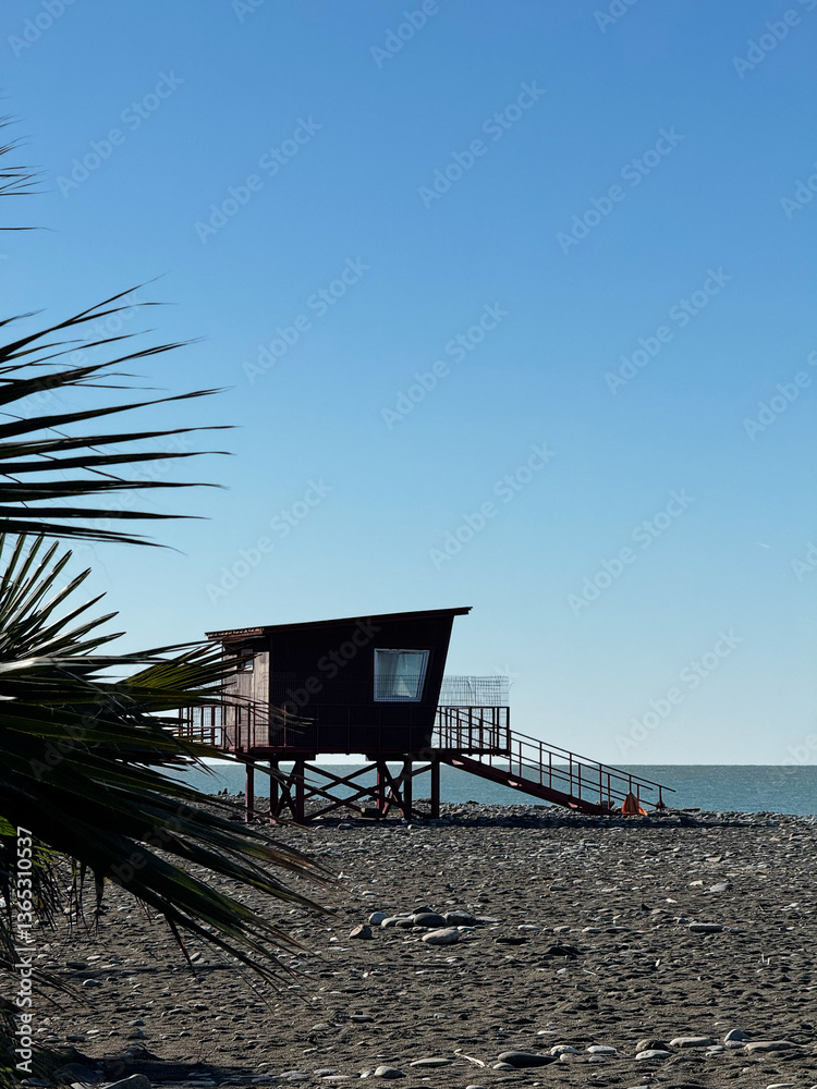 Lifeguard Hut on Rocky Beach Under Clear Blue Sky