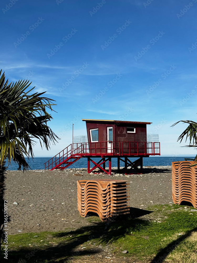 Lifeguard Hut on Beach with Stacked Lounge Chairs