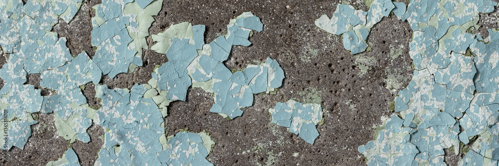 Peeling paint on the wall. Panorama of a concrete wall with old cracked flaking paint. Weathered rough painted surface with patterns of cracks and peeling. Grunge texture for wide panoramic background