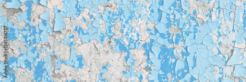 Blue peeling paint on the wall. Old concrete wall with cracked flaking paint. Weathered rough painted surface with patterns of cracks and peeling. High resolution texture for background and design.
