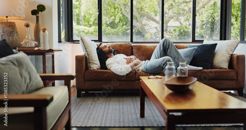 Home, relax and man on sofa, sleeping and resting with weekend break in living room. Apartment, happy person and guy on couch, comfortable and chilling with peace, calm and easy with afternoon nap
