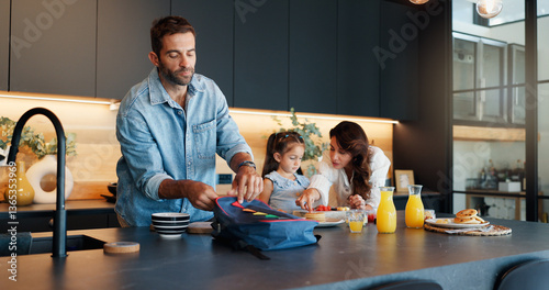 Slika na platnu Parents, child and pack lunch in kitchen with healthy breakfast, getting ready and back to school